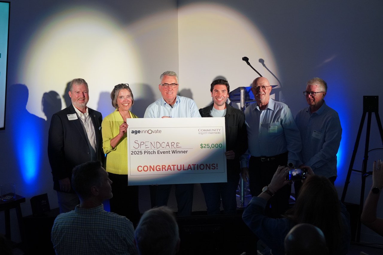 SpendCare team accepting the $25,000 check at AgeInnovate 2025