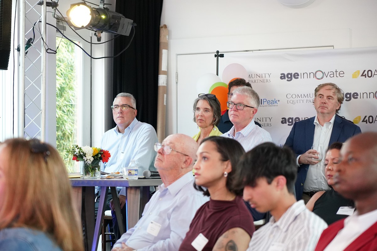 Judges and audience watching a startup pitch at AgeInnovate Nashville 2025